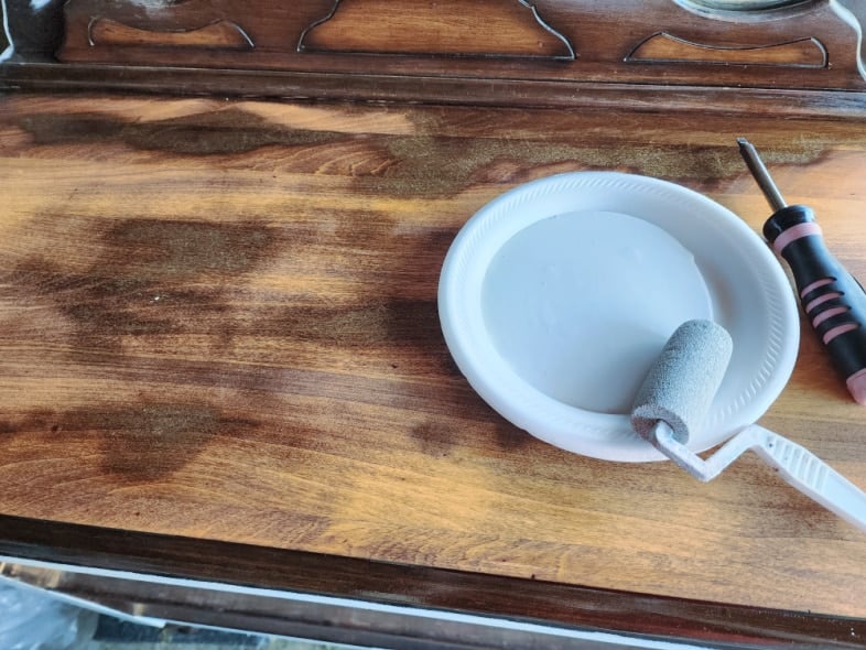 upainted antique dresser top, styrofoam plate with light gray paint and small roller
