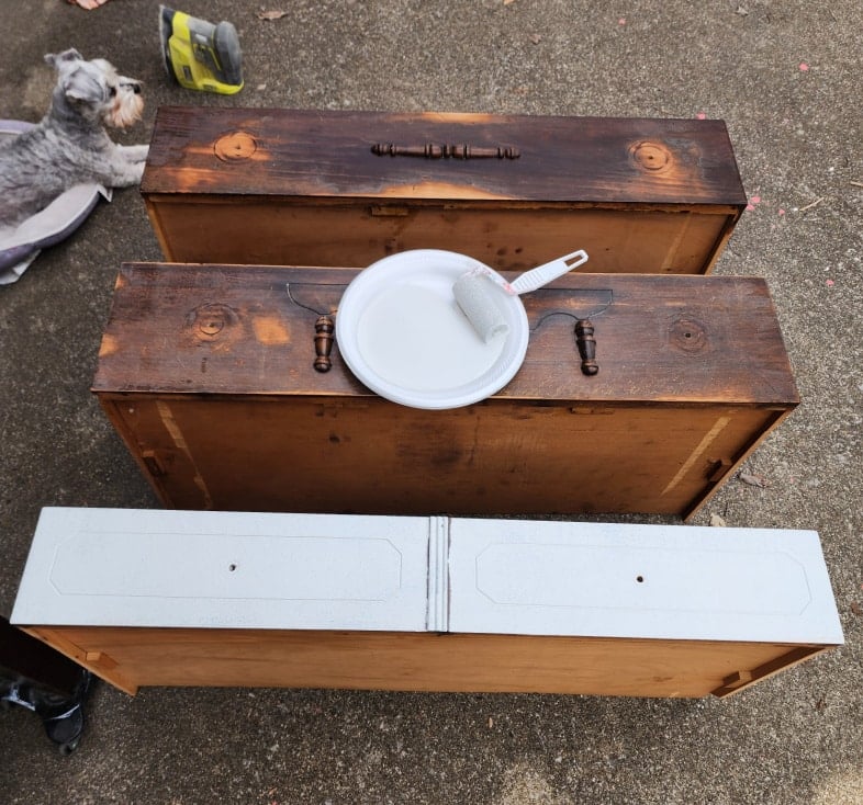 one drawer with first coat of paint, two drawers waiting to be painted