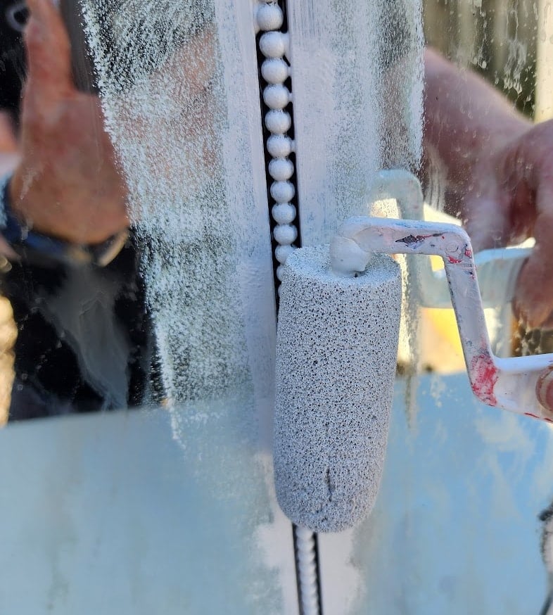 painting beaded trim on antique dresser mirror with a small foam roller