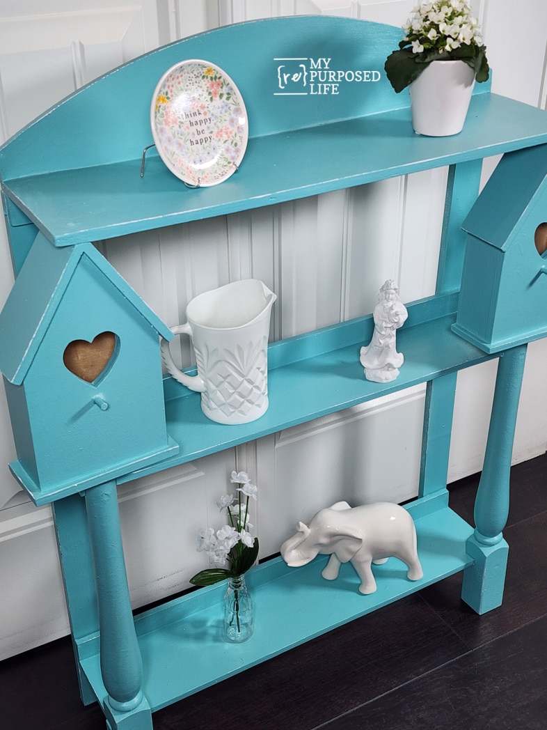 side view of aqua country shelf with white decor