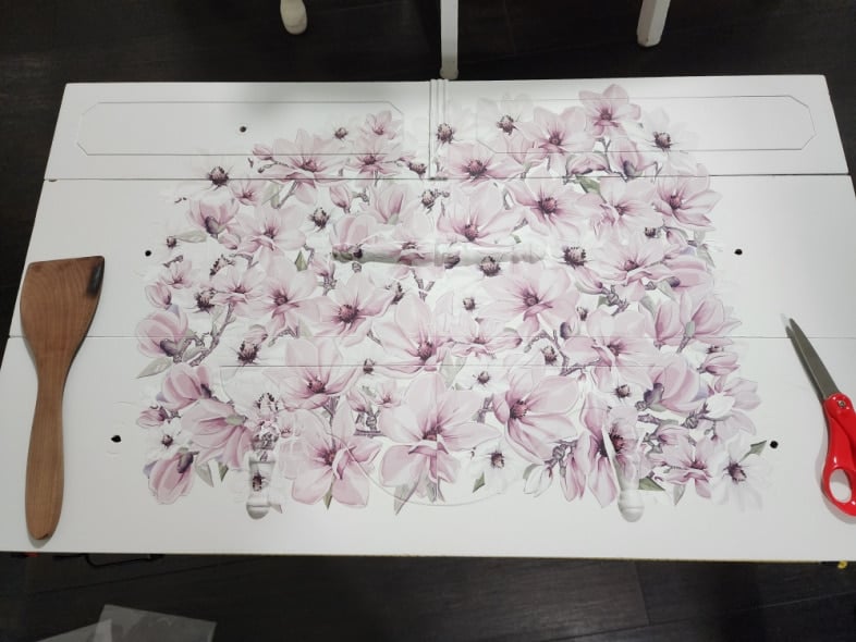 three antique dresser drawers on the floor with magnolia furniture transfers in place