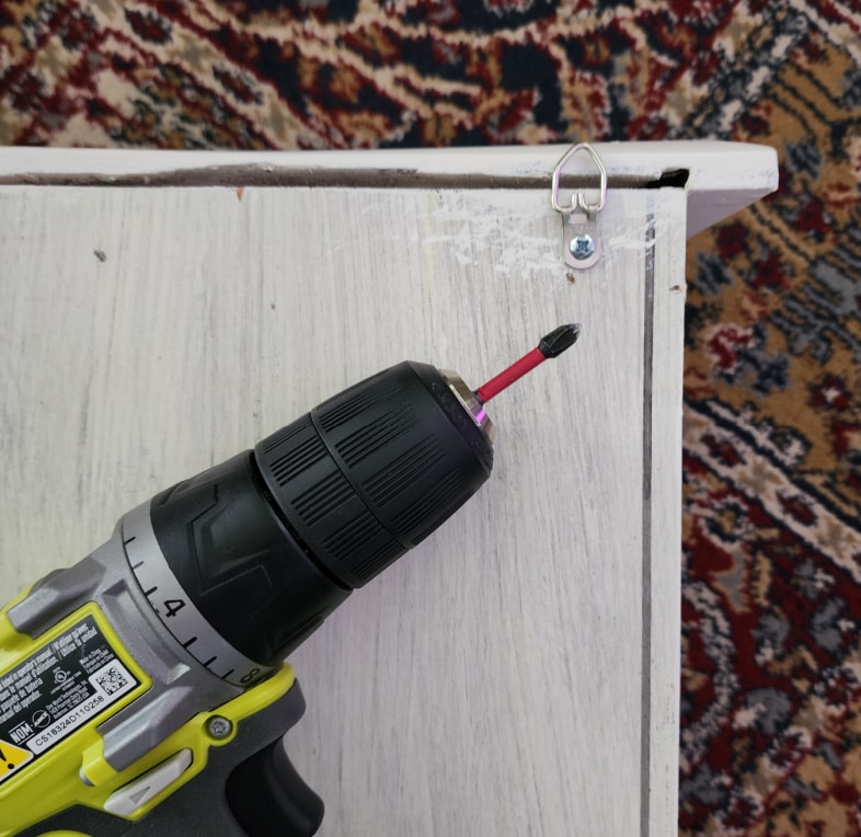 drill on back of cabinet used to attach a d ring for hanging