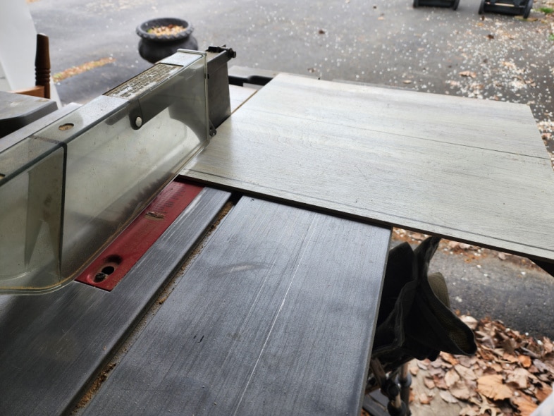 cutting scrap plywood on a table saw