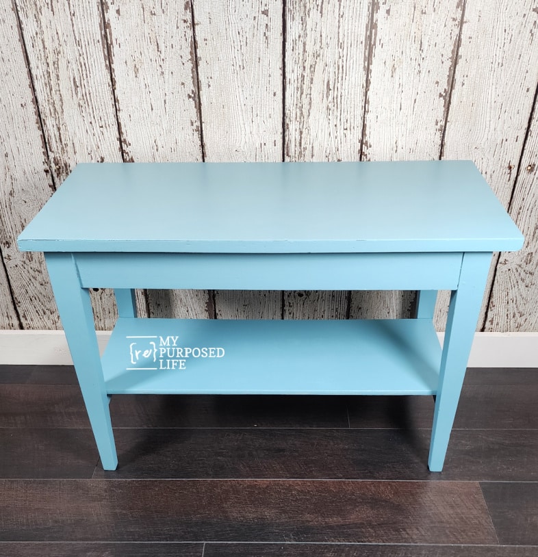 pretty blue piano bench with a lower shelf