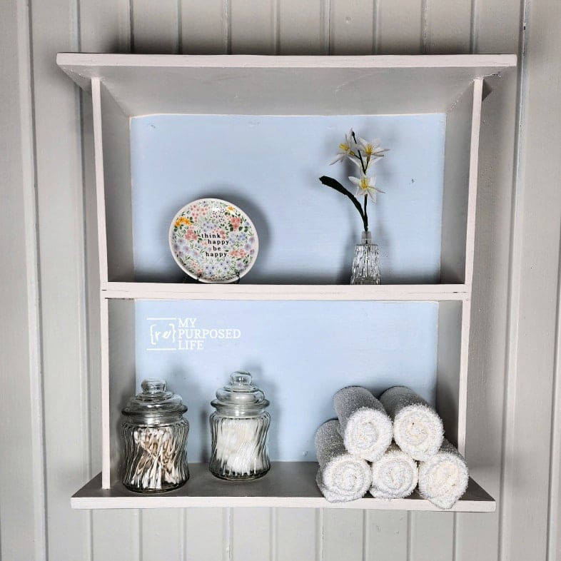 upcycled drawer shelf with bathroom items and decor