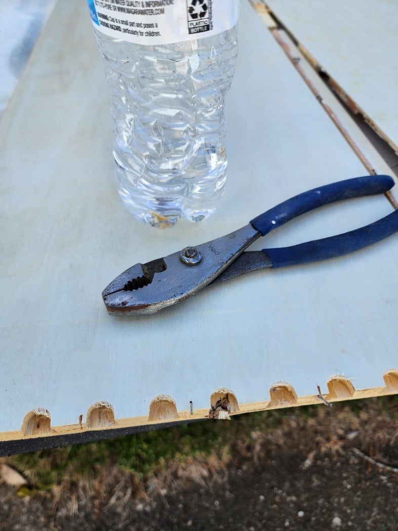 pliers and a water bottle for old staples