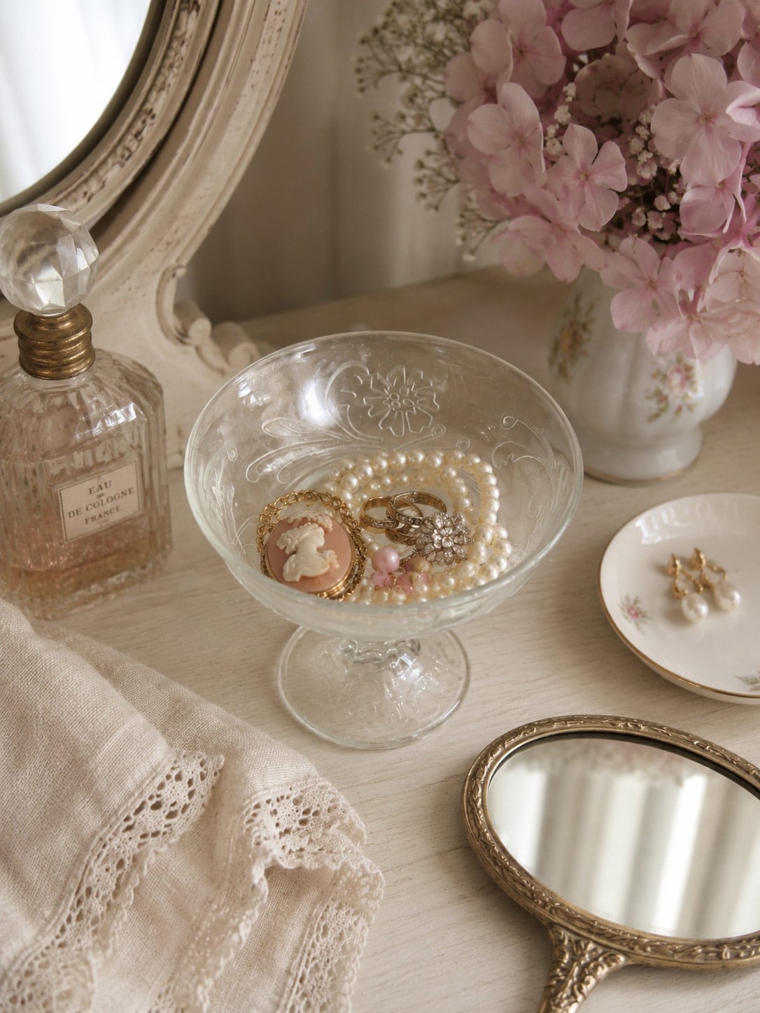 small glass pedestal bowl holding jewelry pieces