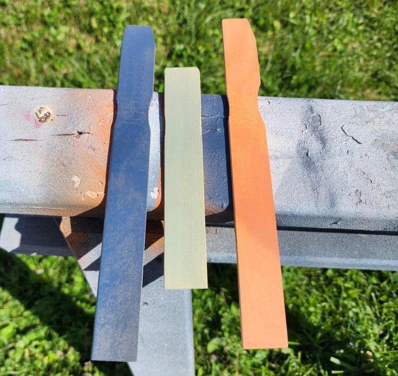 three spray painted paint sticks, blue-green-orange