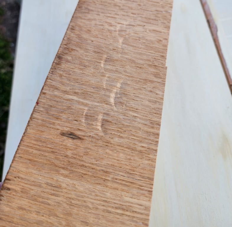 scrap wood piece with hammer dings