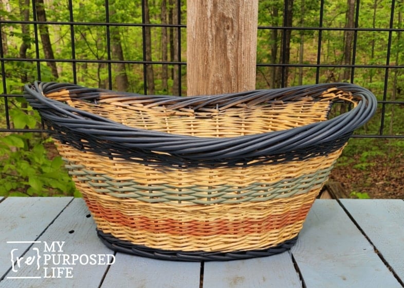 colorful boho farmhouse basket sitting on a blue deck