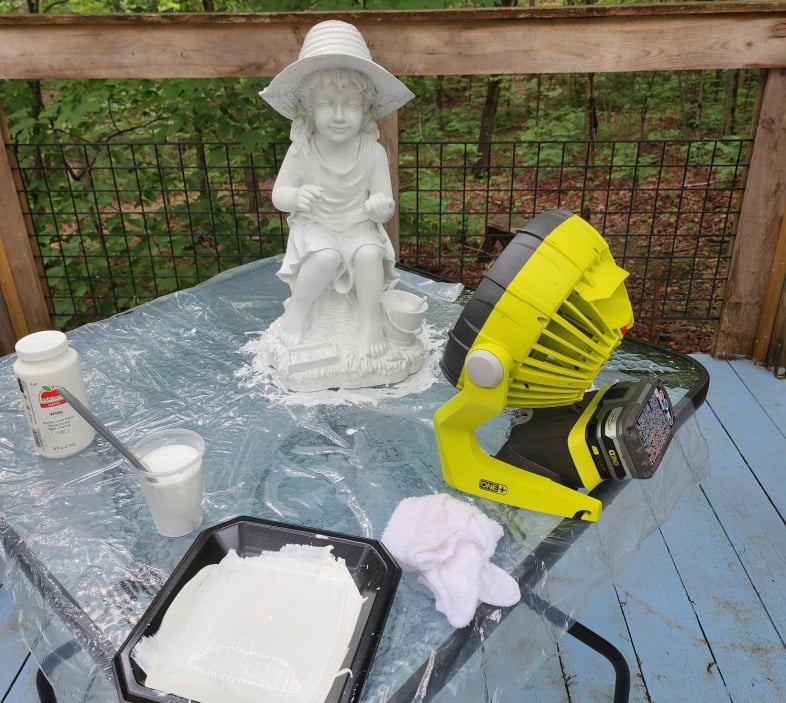 drying a painted statue with a fan