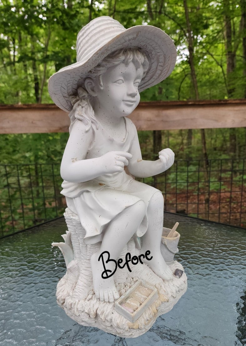 thrift store little girl garden statue before its makeover