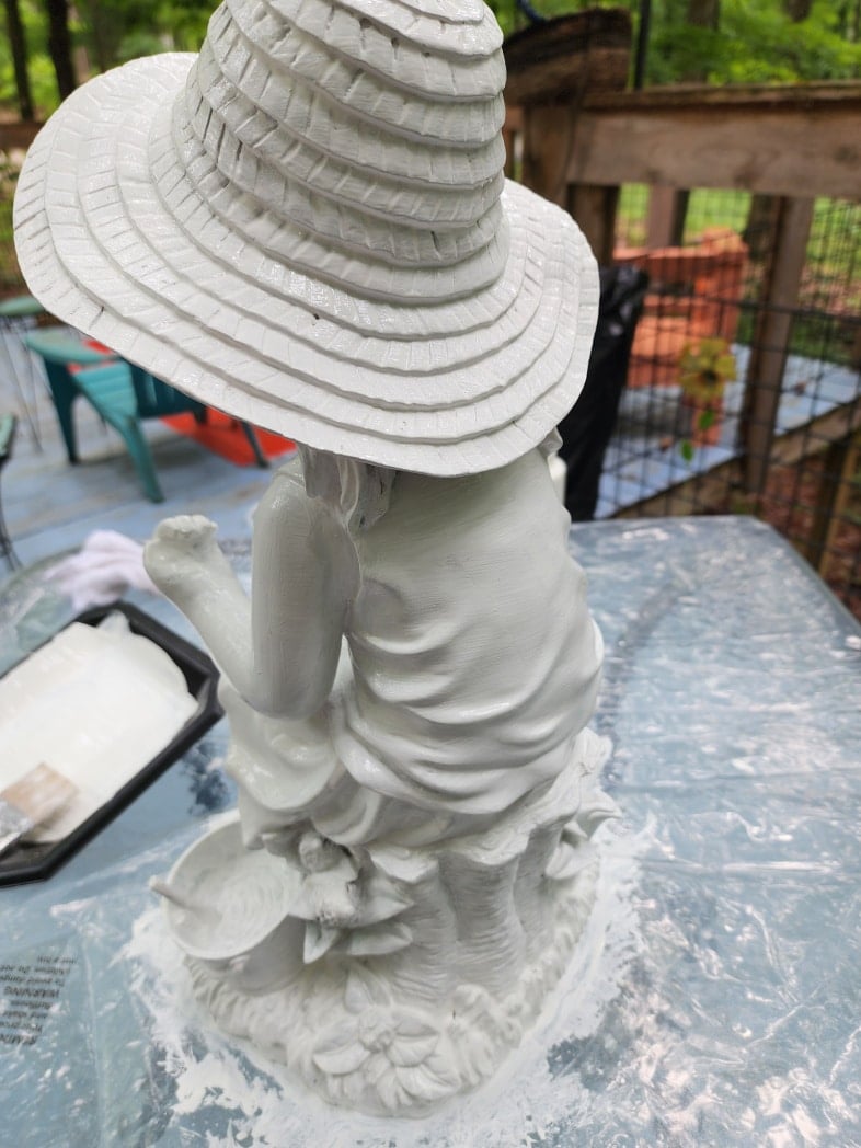 painting a little girl statue white