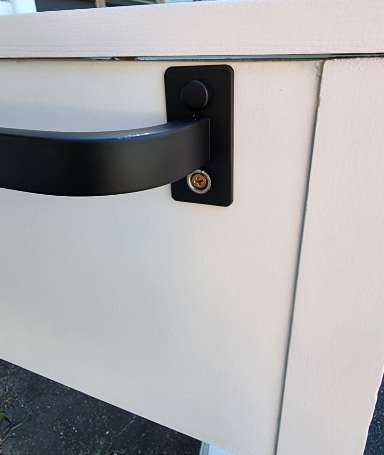 installing a black towel bar to the side of a small kitchen prep station
