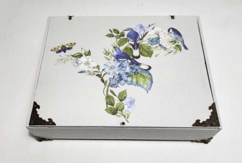 small gray wooden keepsake box with pretty blue and white furniture transfer on the top