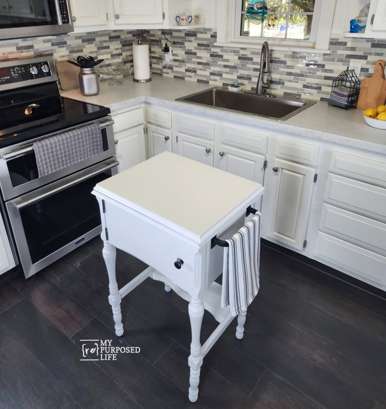 small kitchen island near stove and sink