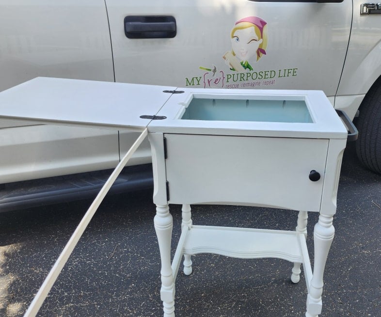 small kitchen island with a board sticking out the front