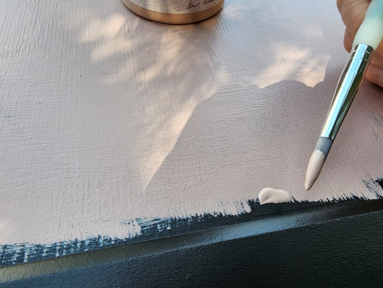 using an artit's brush to trim paint