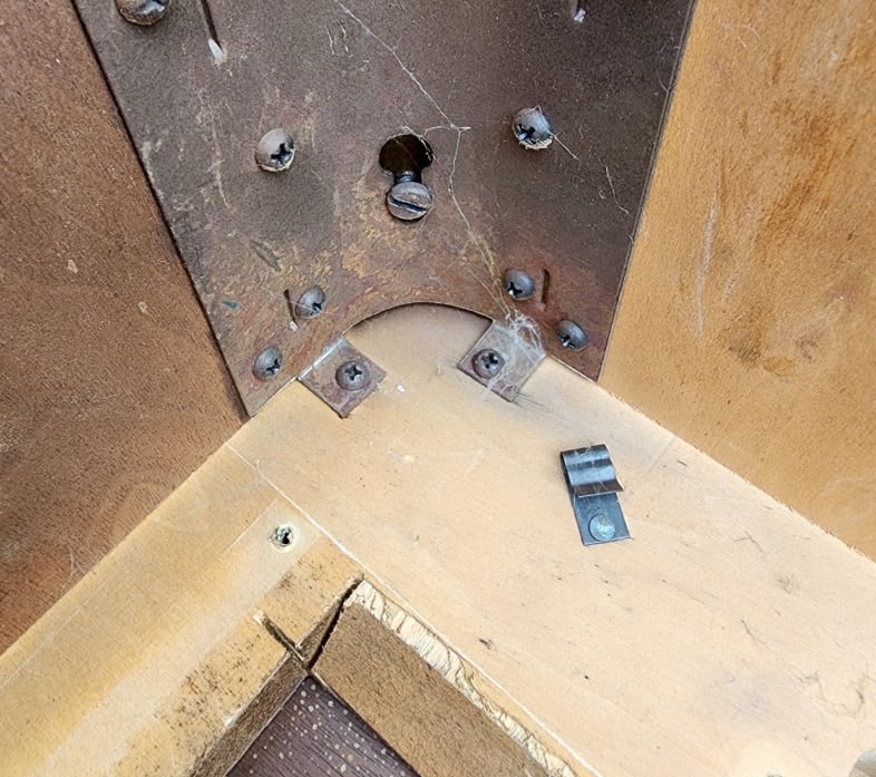 metal leg brace connected to the machine mounting board