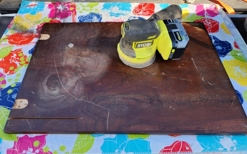  sanding underside of tabletop with an orbital sander