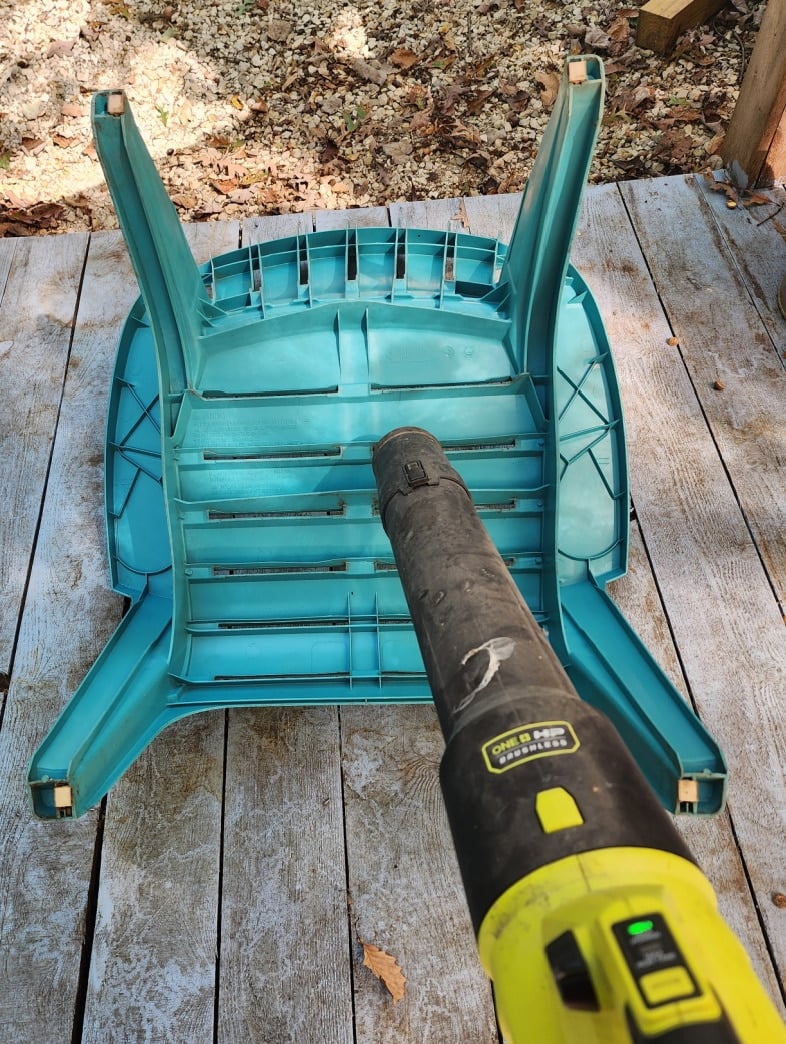 use a leaf blower to dust off a plastic chair