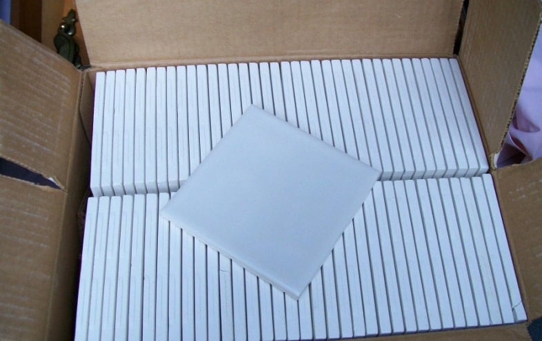 salvaged white tiles in a box