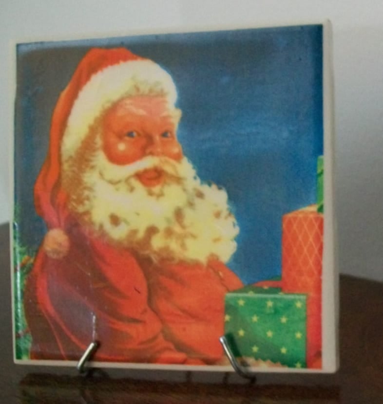 santa napkin decoupage coaster displayed on a small easel