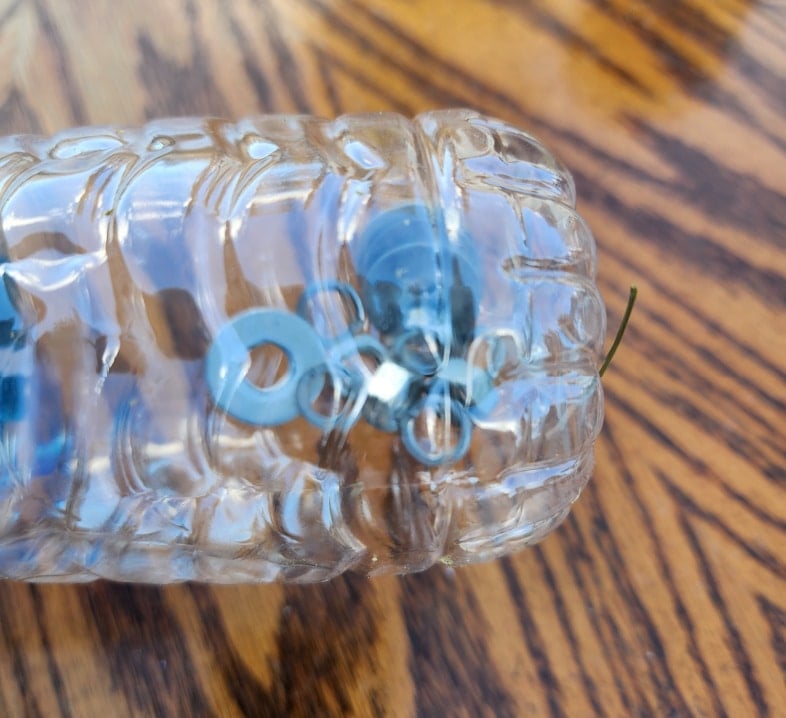 table hardware stored safely in a water bottle
