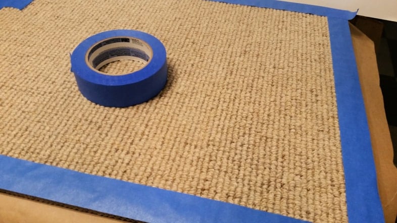 apply painters tape around the perimeter of a cheap rug