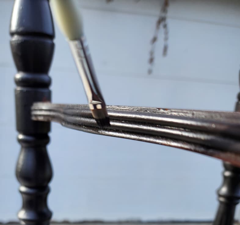 a small artists brush for painting detailed area of table