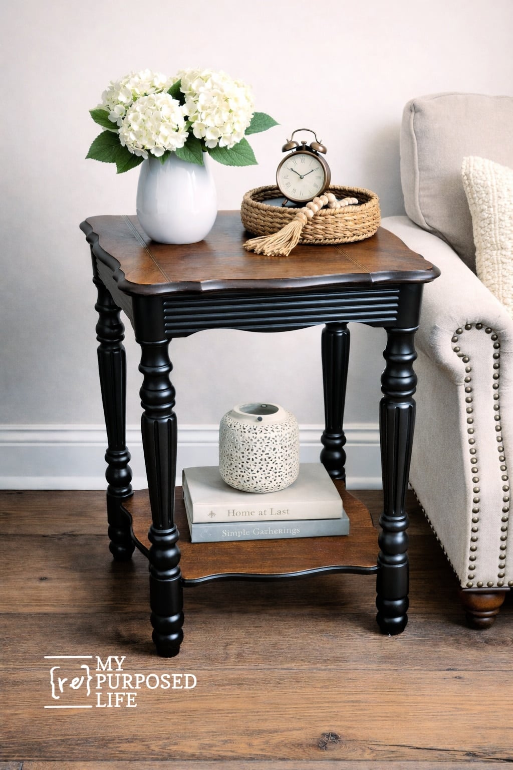 black and hickory antique side table next to a chair