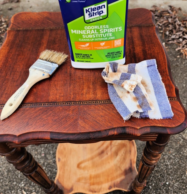 wiping tabletop clean with mineral spirits