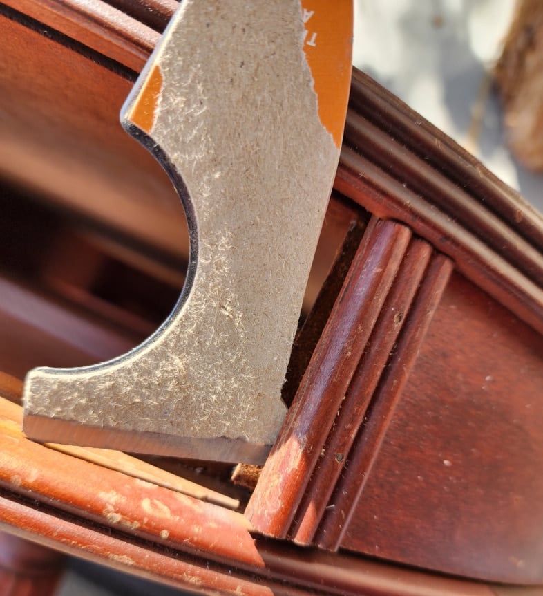 pry drum table trim with a painters tool