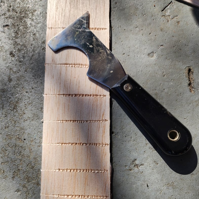 use painters tool to perforate balsa wood for bending