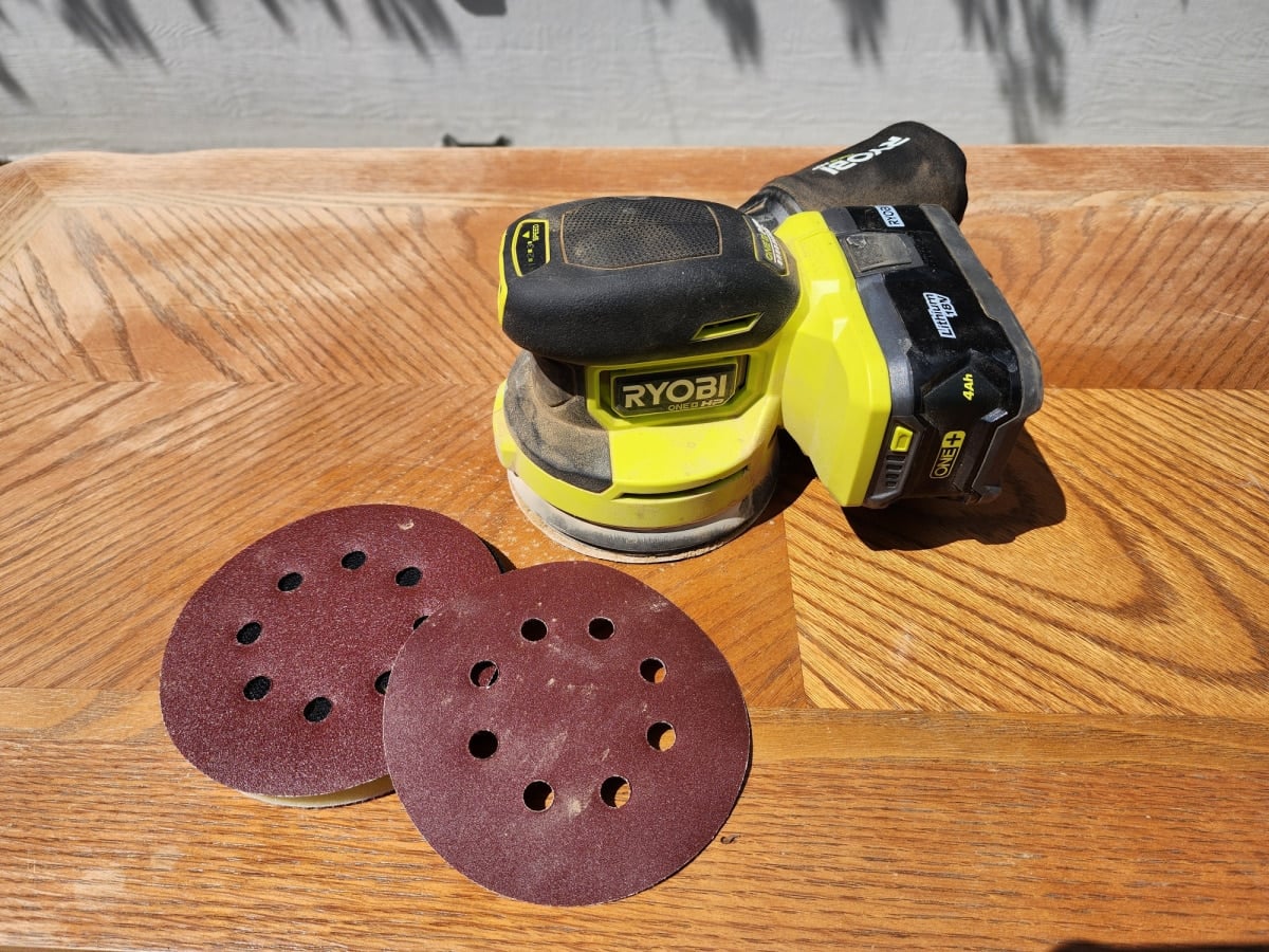 orbital sander resting on coffee table