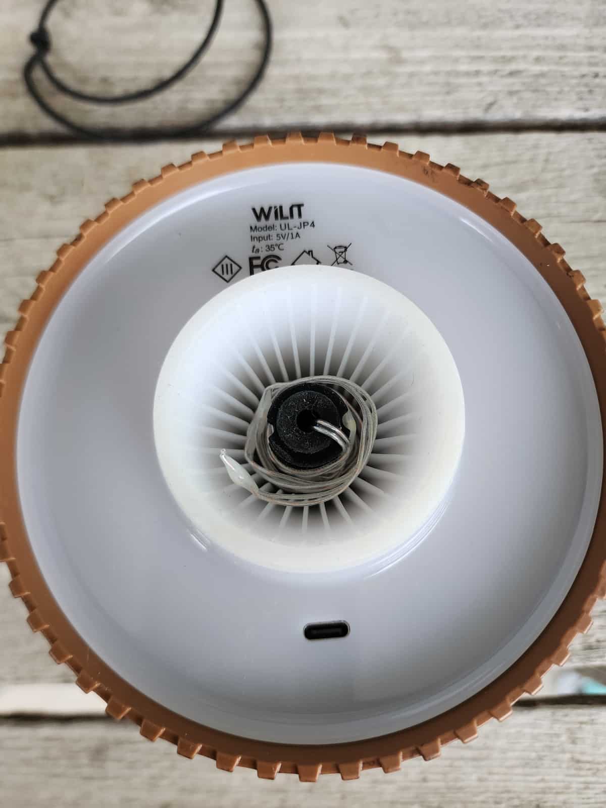 string lights are wound around the cork of the wireless shade