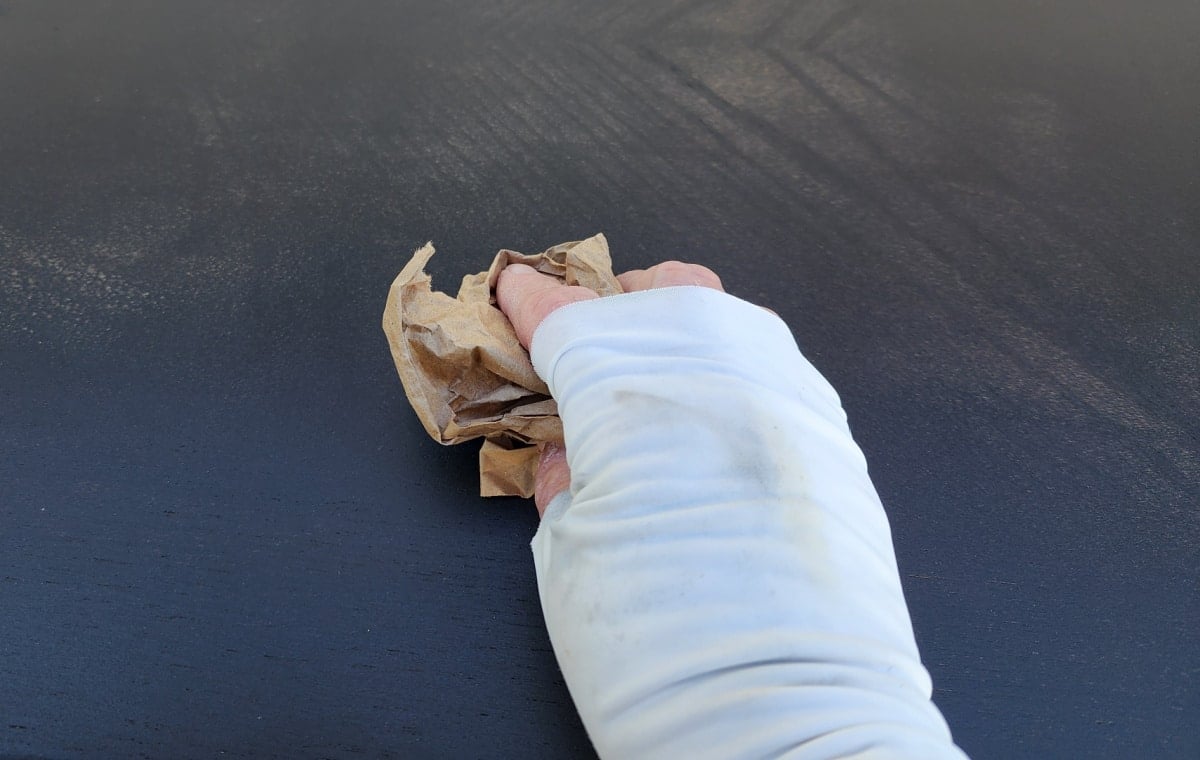 using brown craft paper to sand bewteen coats