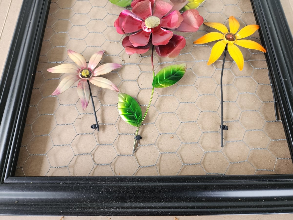 DIY metal flower wall art attached with zip ties cut off