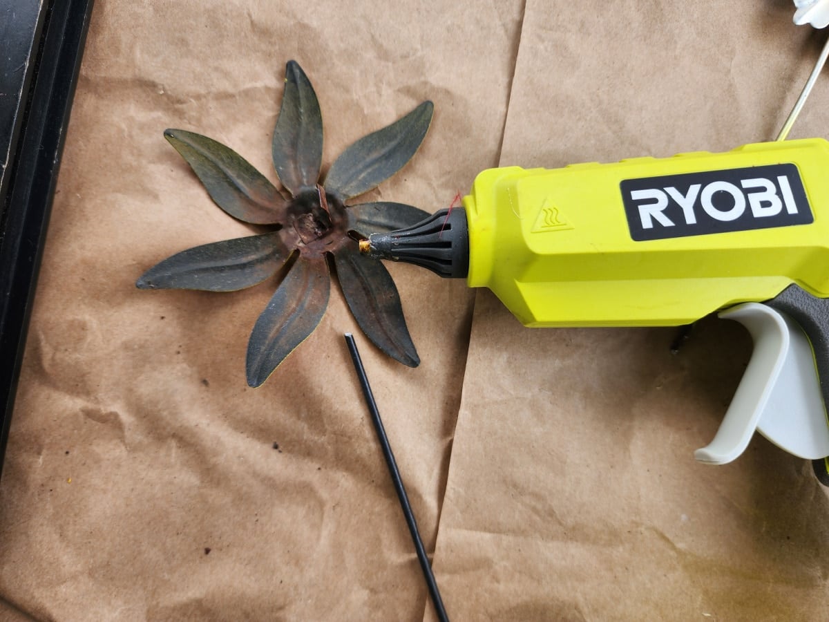 add a stem to a metal garden flower with hot glue