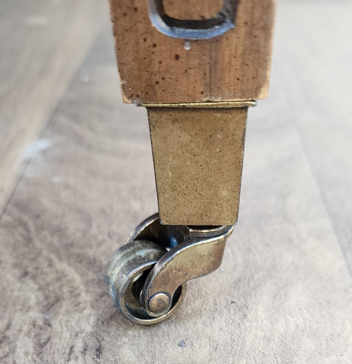 closeup of vintage end table caster wheel