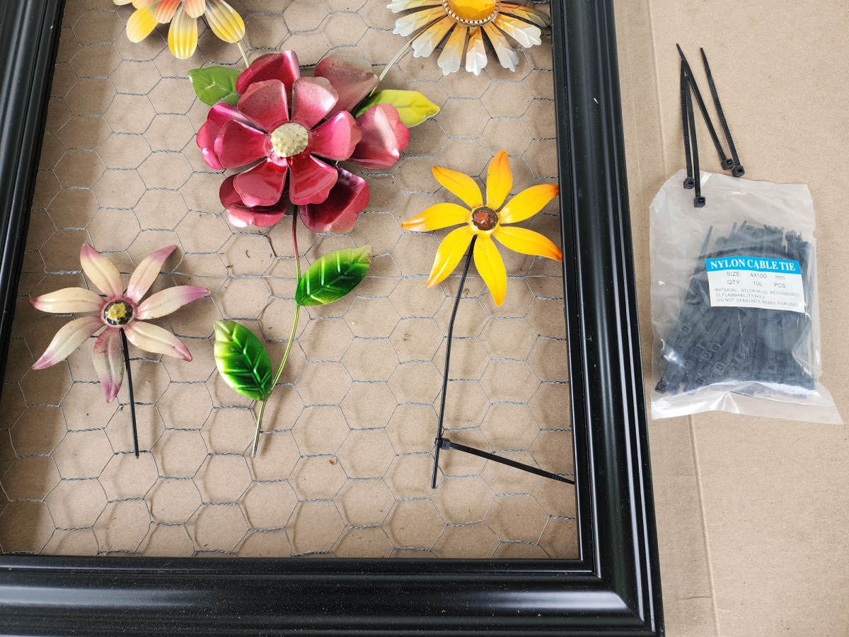 securing metal garden flowers onto chicken wire with zip ties