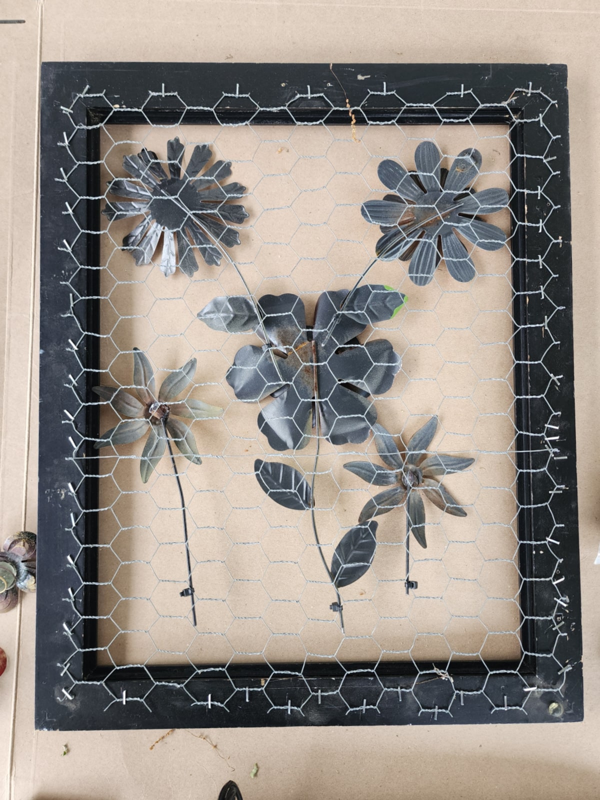 view from the back of the framed chicken wire metal flowers
