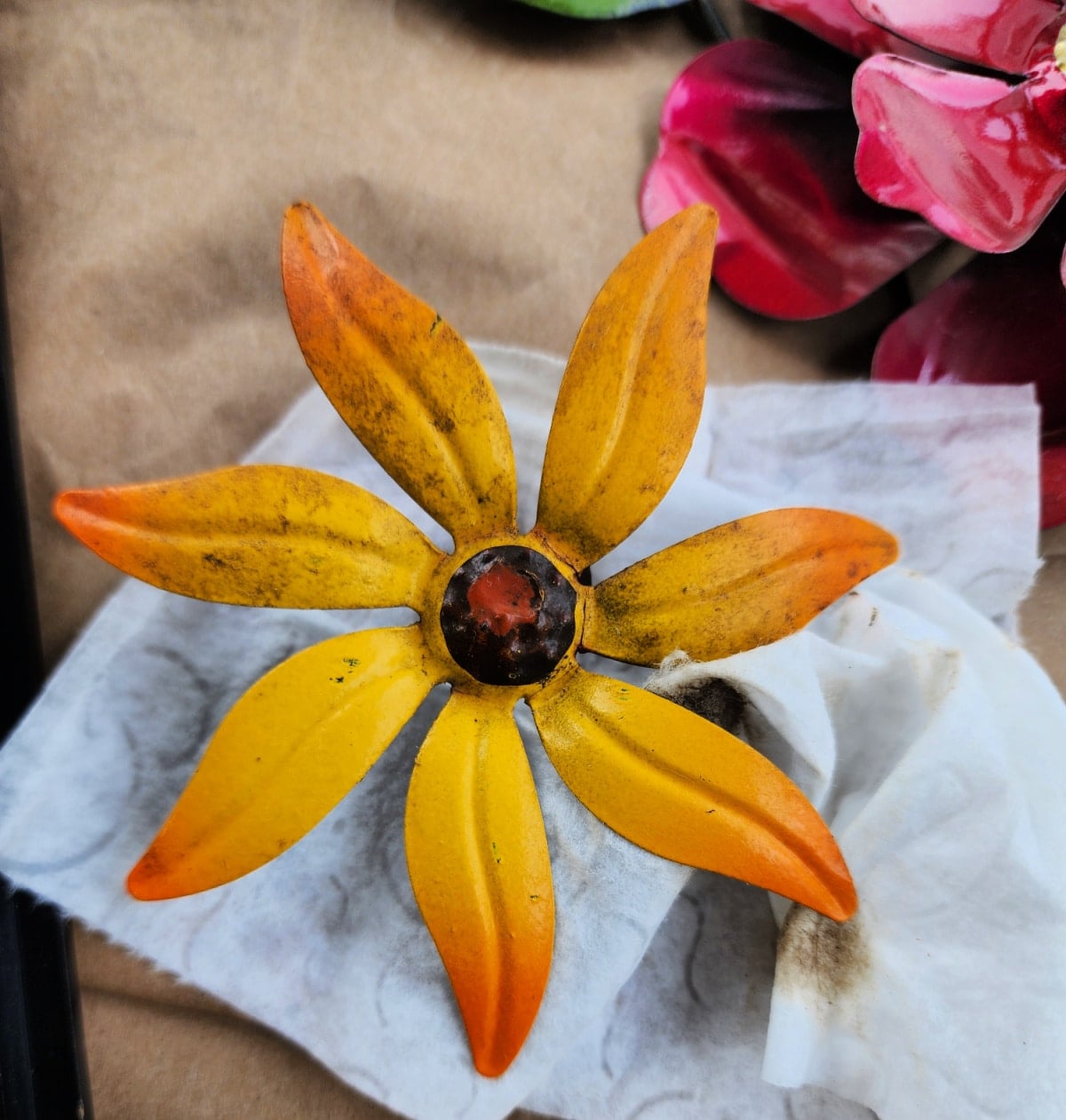 wipe off metal garden flower with a baby wipe