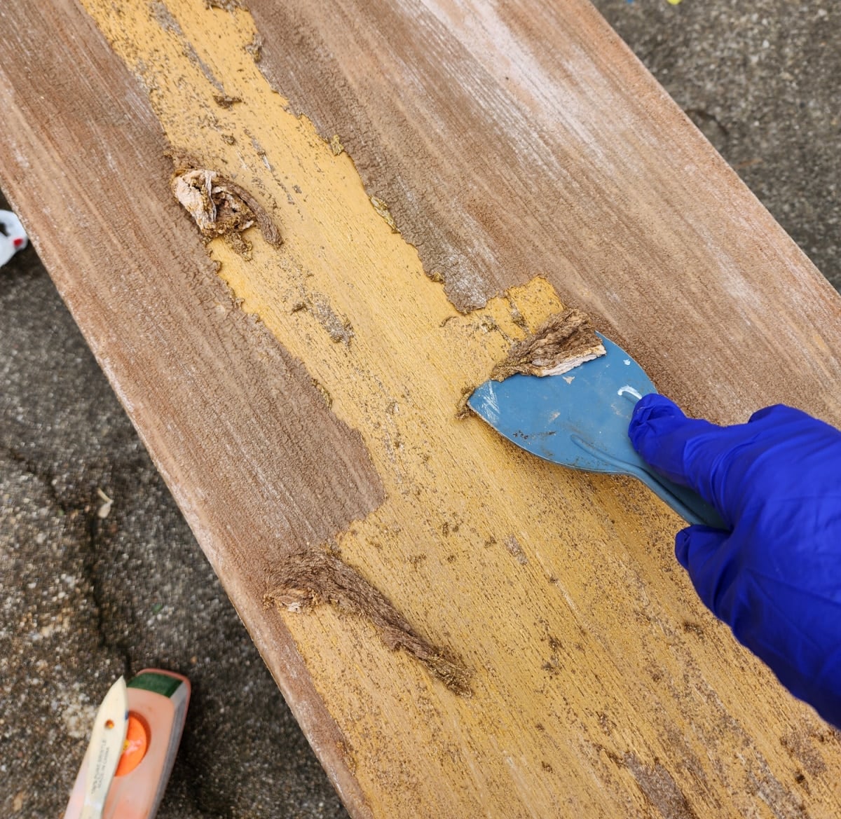 scrape paint away with plastic scraper