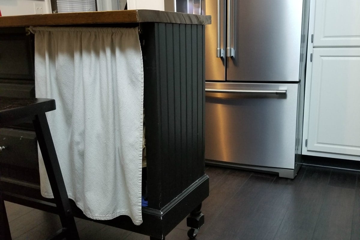 a small curtain covers the kneehole of the former desk