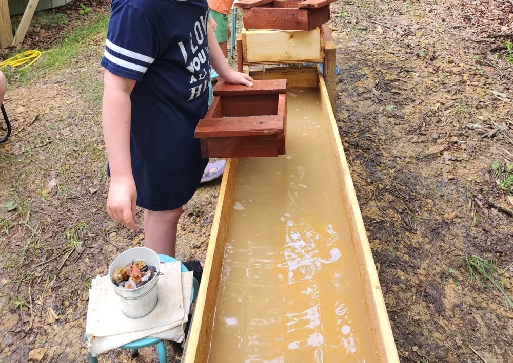sifting rocks placing them in a bucket