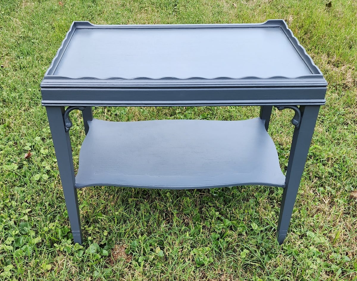 dark gray tiered thrift store table outside