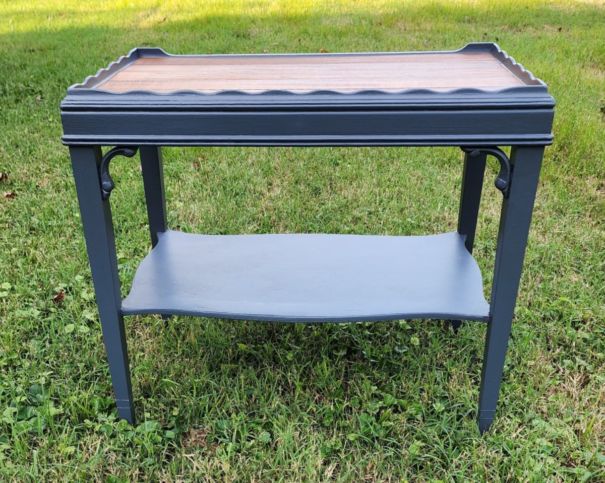 dark gray tiered thrift store table with wood plank top
