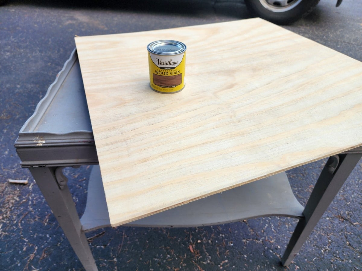 plywood and stain resting on a small side table