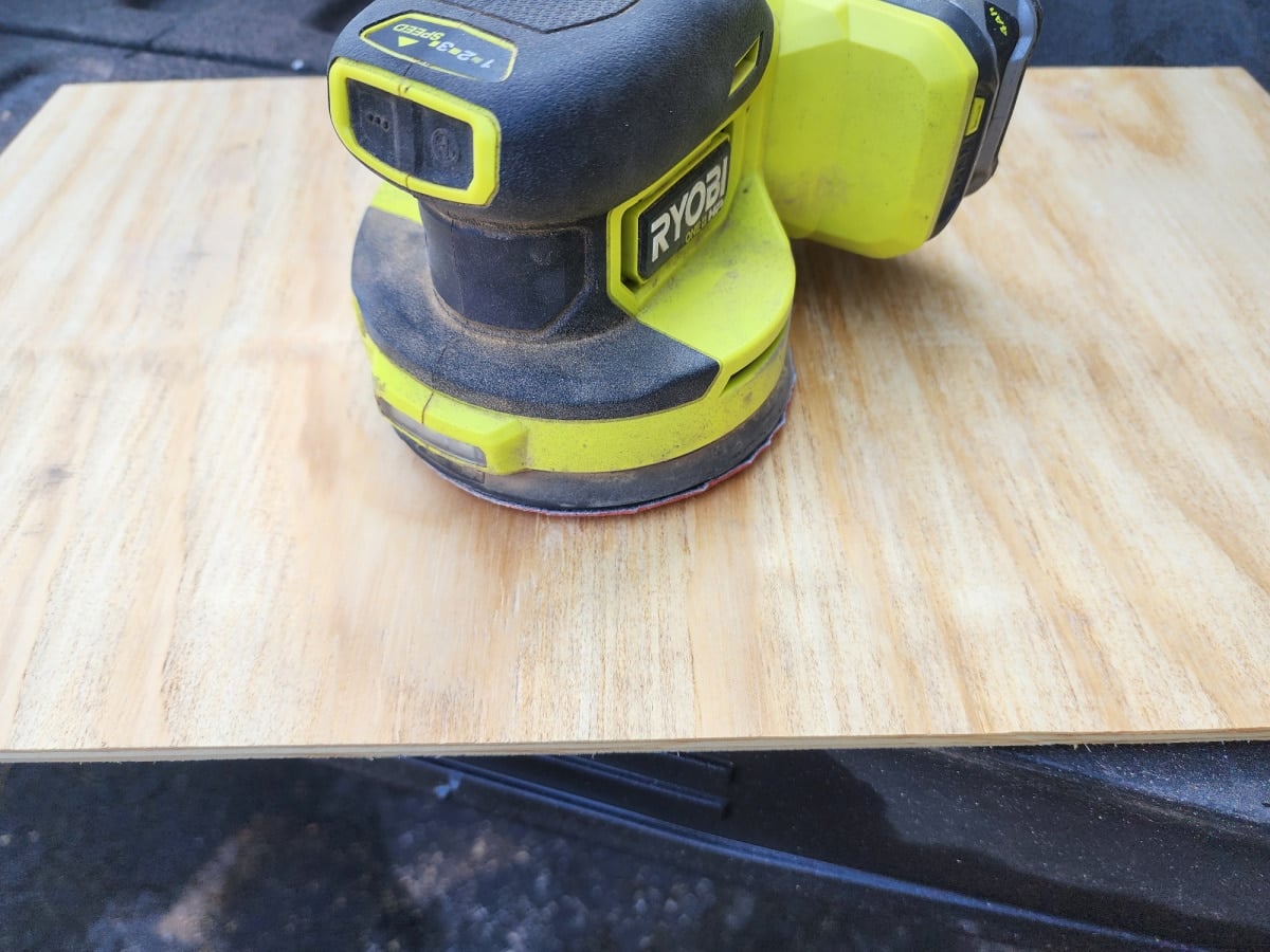 sanding plywood table top with an orbital sander